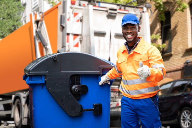 Man smiling collection a collection waste bin.